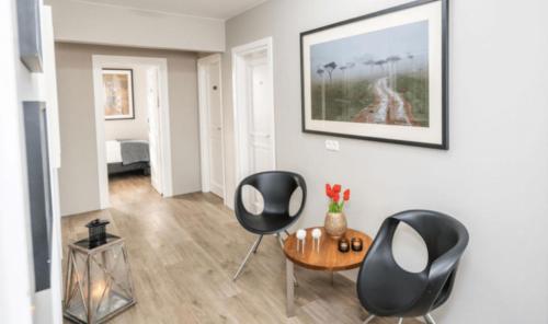 a living room with two chairs and a table at Guesthouse Keflavik by Reykjavik Keflavik Airport in Keflavík