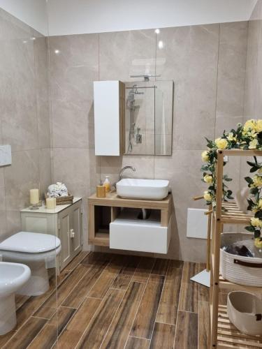 a bathroom with a sink and a toilet at ASTRA Guest House in Taranto