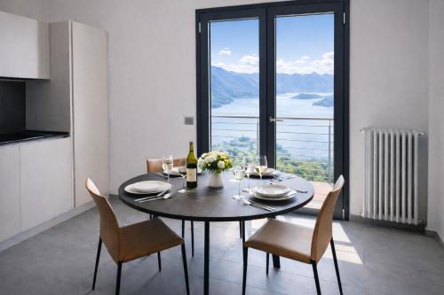 a dining room with a table and chairs with a view at Splend'Or - A Real Paradise in Perledo