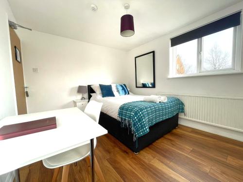 a small bedroom with a bed and a window at The Studios, Dedworth Road, by Accommodation Windsor in Windsor
