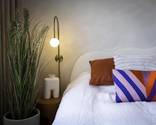 a bedroom with a bed with a pillow and a plant at Odit B&B in Bruges
