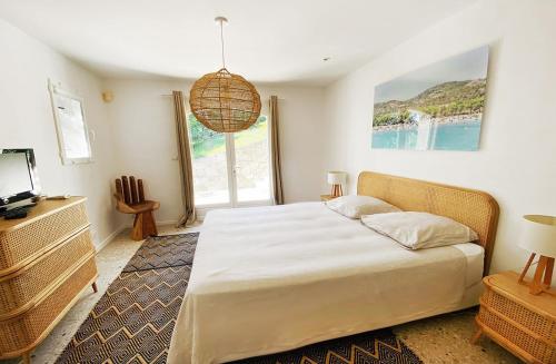 a bedroom with a large bed and a television at Luxury Villa, Infinity Pool, Beach 5 min in Ramatuelle
