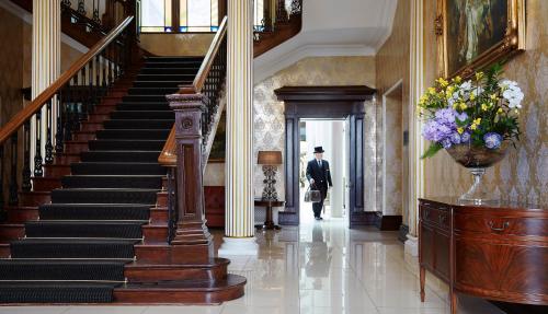 a man walking down a staircase in a building at Lyrath Estate in Kilkenny