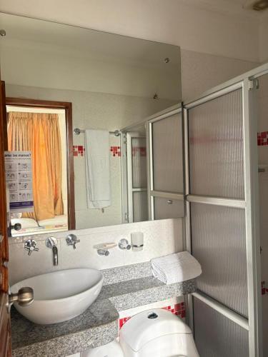 a bathroom with a sink and a mirror at Hotel Chucarima in Cúcuta