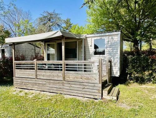 a wooden cabin with a tent on the grass at Camping 3 étoiles - Piscine - ccbfgbf in Collias