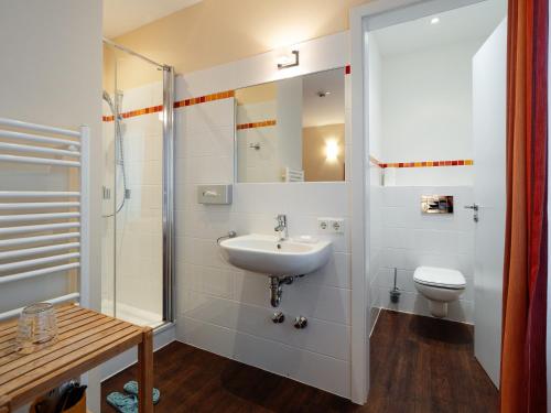 a bathroom with a sink and a toilet at Hotel Gutenberg in Westerland