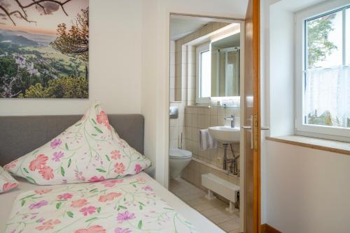 a small bathroom with a bed and a sink at Haus am Bach in Bad Wörishofen