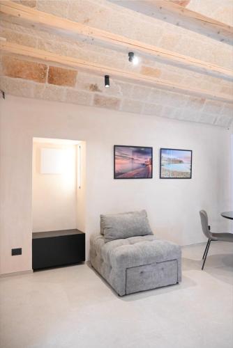 a living room with a couch and a table at CastelFidardo Dimore - MONOPOLI in Monopoli