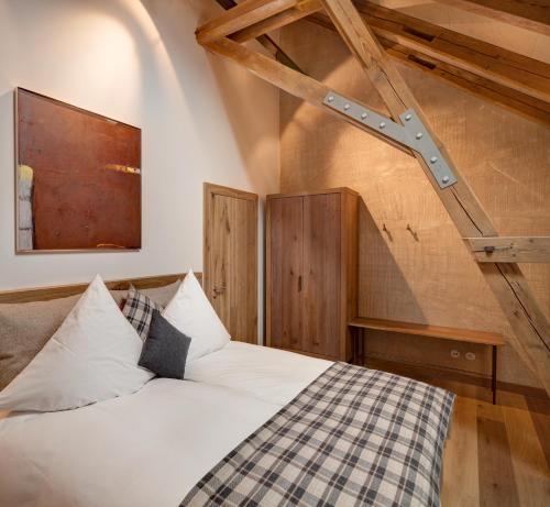 a bedroom with a white bed and wooden ceilings at AlmRefugio in Neumarkt in der Oberpfalz