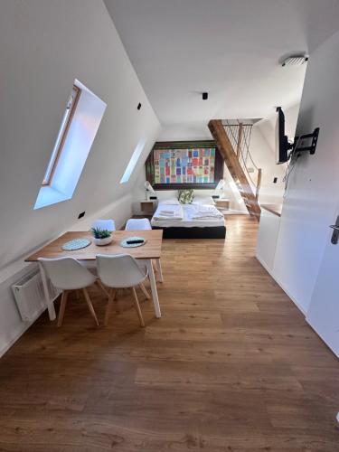 a room with a table and chairs and a bed at Appartementhaus Obertrave in Lübeck