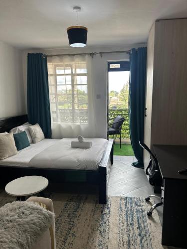 a bedroom with a bed and a table and a window at JOJO Staycations in Rungiri