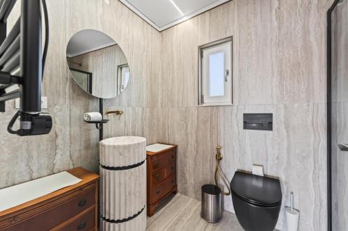 a bathroom with a toilet and a mirror at Casa Mimosa by Algarve Holidays in Vale do Lobo