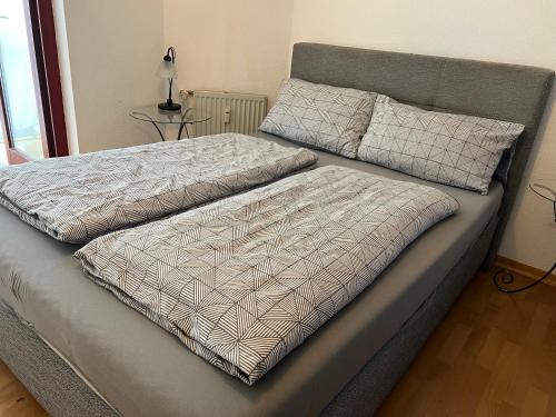 a bed with two pillows on top of it at Very nice, Central and fully Furnished Apartment in Bonn