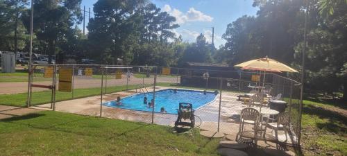 aenced in swimming pool in a park at Texarkana KOA Journey in Texarkana
