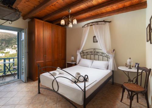 a bedroom with a bed and a table and a window at villa eirini in Kourélion
