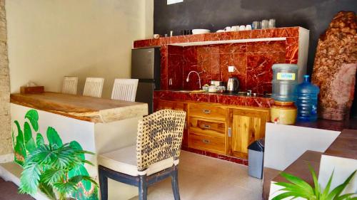 a kitchen with a counter and a table and a counter top at Pranajaya oasis in Tejakula