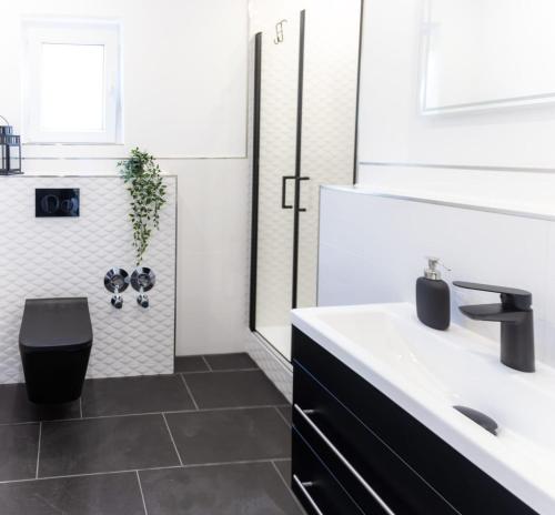 a white bathroom with a sink and a toilet at Moselgoldt in Burg