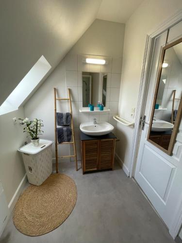 a bathroom with a sink and a mirror at Centre Treguier L escapade des quais in Tréguier