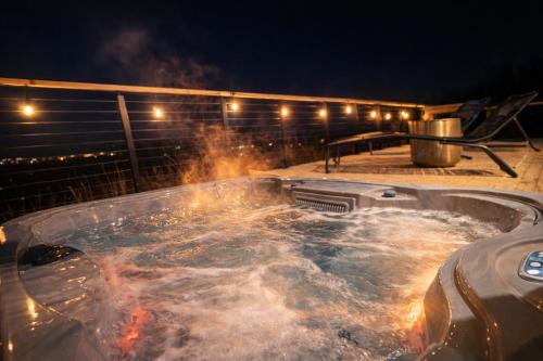 a hot tub on a deck at night at Luxury Shepherds Hut with Hot Tub Valley Views in Scarborough