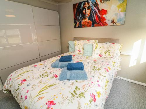 a bedroom with a bed with towels on it at The Nest Lodge 55 in Grantham