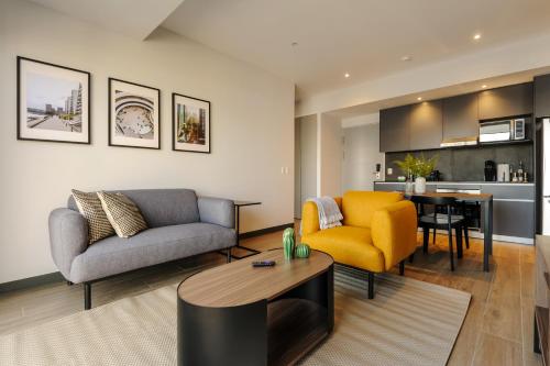 a living room with a couch and a table at Amazing Apartments in the Heart of Interlomas in Mexico City