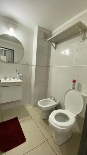 a white bathroom with a toilet and a sink at PB-Súper dpto Morón centro in Morón