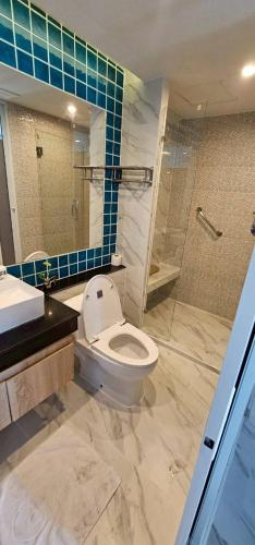 a bathroom with a toilet and a sink and a shower at Condo D-Eco Wellness Center A8721 in North Pattaya