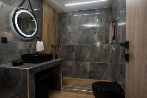 a bathroom with a black sink and a mirror at Casa Gemma 3 in Rhodes Town