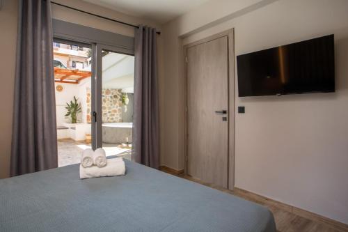 a bedroom with a bed and a flat screen tv at Casa Gemma 3 in Rhodes Town