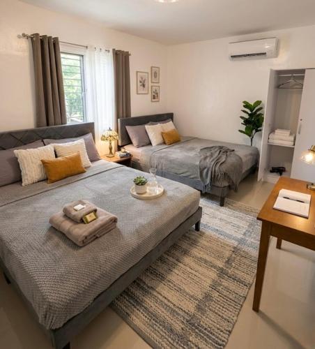 a living room with a bed and a couch at La Residencia Homestay in Digos