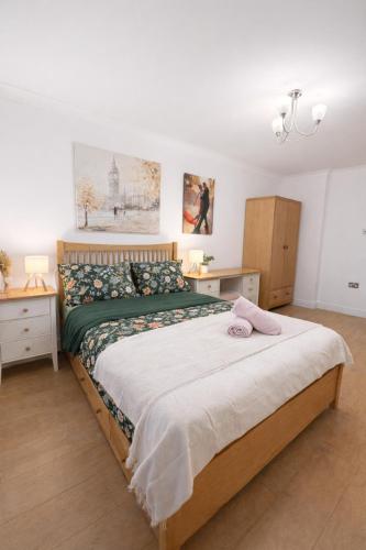 a bedroom with a large bed and two night stands at Sutton Cosy Rooms in Sutton