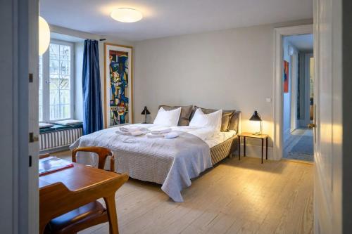 a bedroom with a bed and a table and a table sidx sidx sidx at Holsteins Palace Luxury Apartment in Copenhagen