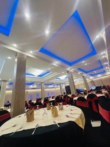 a dining room with a large table and red chairs at Hotel Divine Light Monaragala in Monaragala