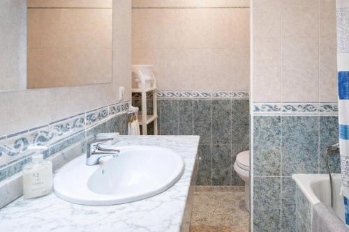 a bathroom with a sink and a toilet at Cala Paradiso in Tossa de Mar