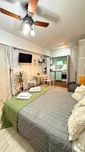 a bedroom with a large bed with a ceiling fan at Monoambiente Viamonte in Buenos Aires