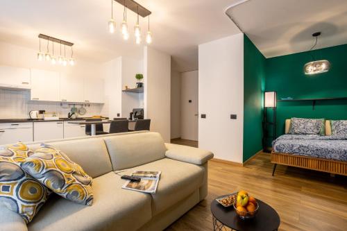 a living room with a couch and a kitchen at Lakeside Lugano in Lugano