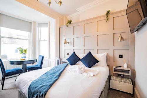a bedroom with a bed with a table and chairs at Marina View Studio - Harbour in Dublin