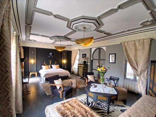 a hotel room with a bed and a table at Dar HISANE in Marrakesh