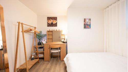 a bedroom with a bed and a desk in a room at STR Stay Bangbae in Seoul