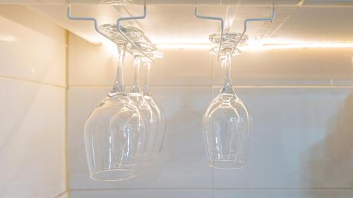 three clear glass vases hanging on a wall at STR Stay Bangbae in Seoul