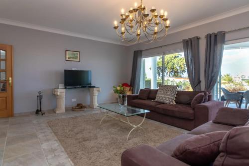 a living room with a couch and a table at Villa Ocean Blue Ocean views Walk to beach Pool in Ferragudo