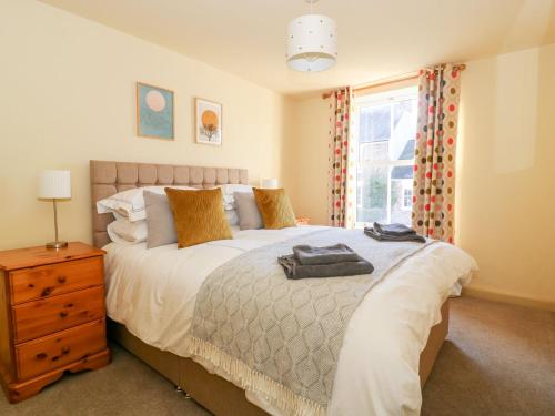 a bedroom with a large bed and a window at Old Post Office in York