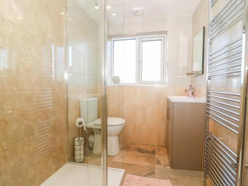 a bathroom with a toilet and a glass shower at Old Post Office in York