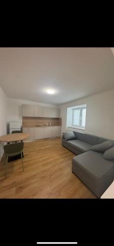 a living room with a couch and a table at KAVE Obchodná Apartments in Bratislava