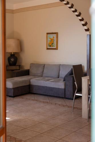 a living room with a couch and a table at Tra Tetti e Mare - HelloElba in Portoferraio