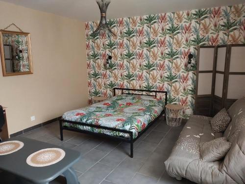 a small bedroom with a bed and a couch at Gite les Campanules in Monthermé