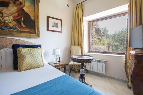 a bedroom with a bed and a window at Il Monastero Collection in Rome