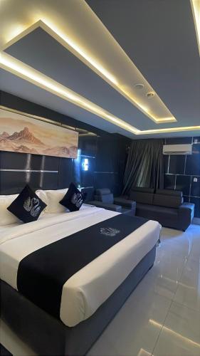 a bedroom with a large bed and a couch at Dephantom Continental Hotel in Lagos