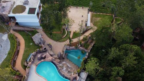 an aerial view of a house with a swimming pool at Crystal Falls Wayanad in Wayanad