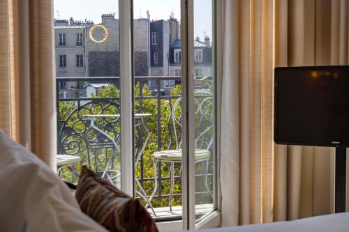 a hotel room with a view of a balcony at Hôtel de Banville in Paris